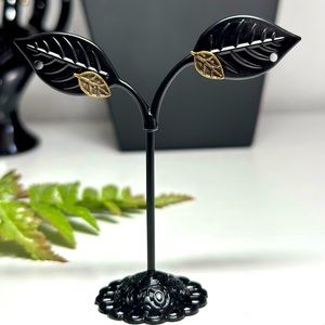 A Pair of Earrings With Small Leaves